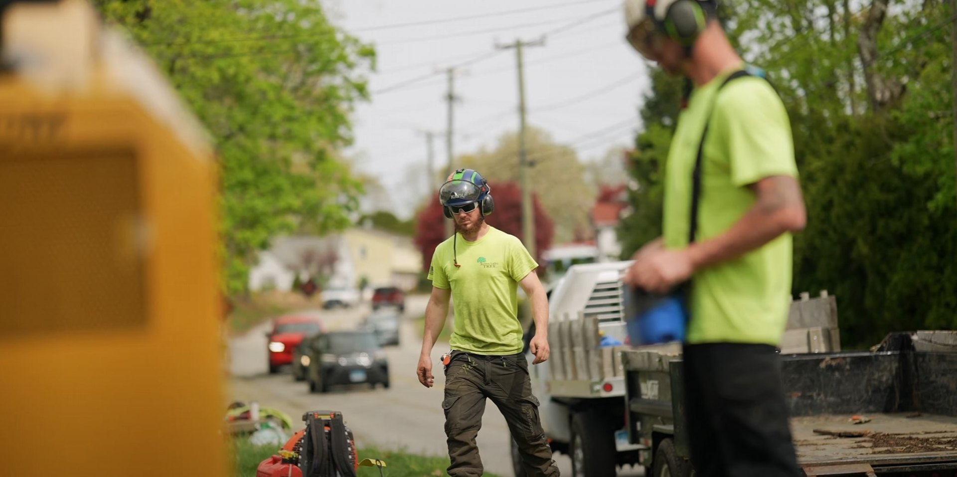 Residential tree services - Professional crew with commercial-grade equipment Tree service crew working on residential street with professional equipment and safety gear
