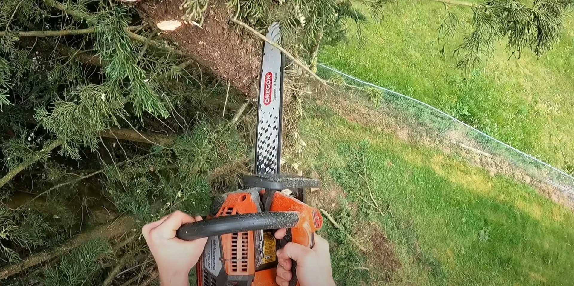 Professional tree cutting tools - High-quality equipment for precision work Professional chainsaw being used for precise tree cutting and pruning work in residential landscape
